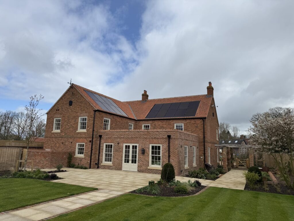 large house in red brick with solar panels